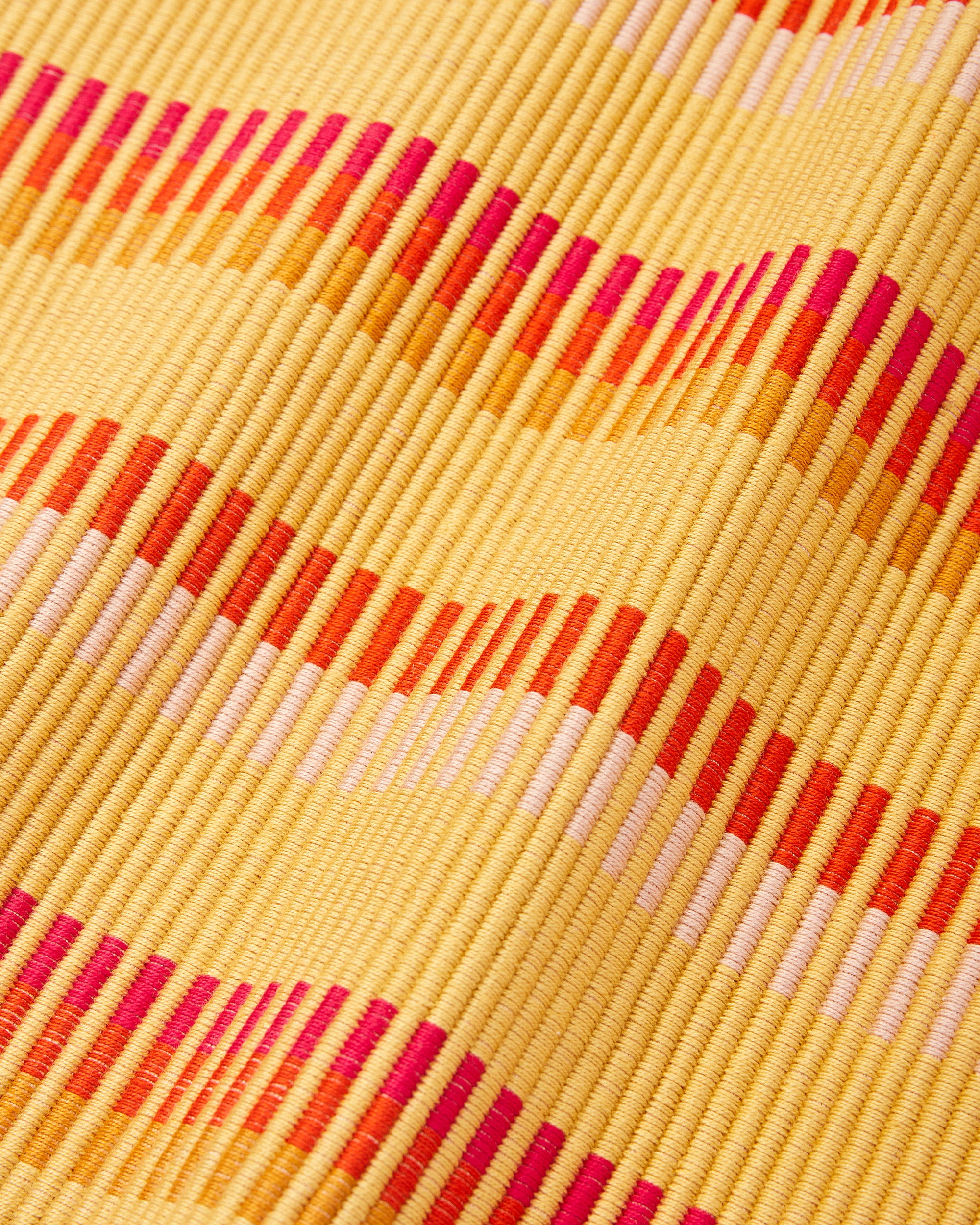 Close up detail of ethically handwoven MINNA cotton placemat in goldfinch, gold yellow, orange, fuschia