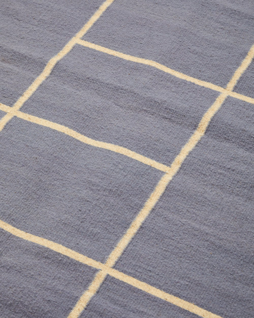 close-up detail ethically handwoven natural wool rug in lilac, naturally dyed