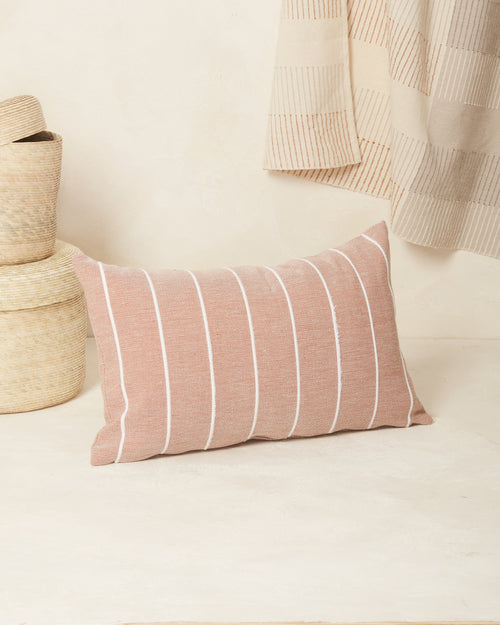 Ethically handwoven decorative MINNA throw pillow with clay and cream stripes.