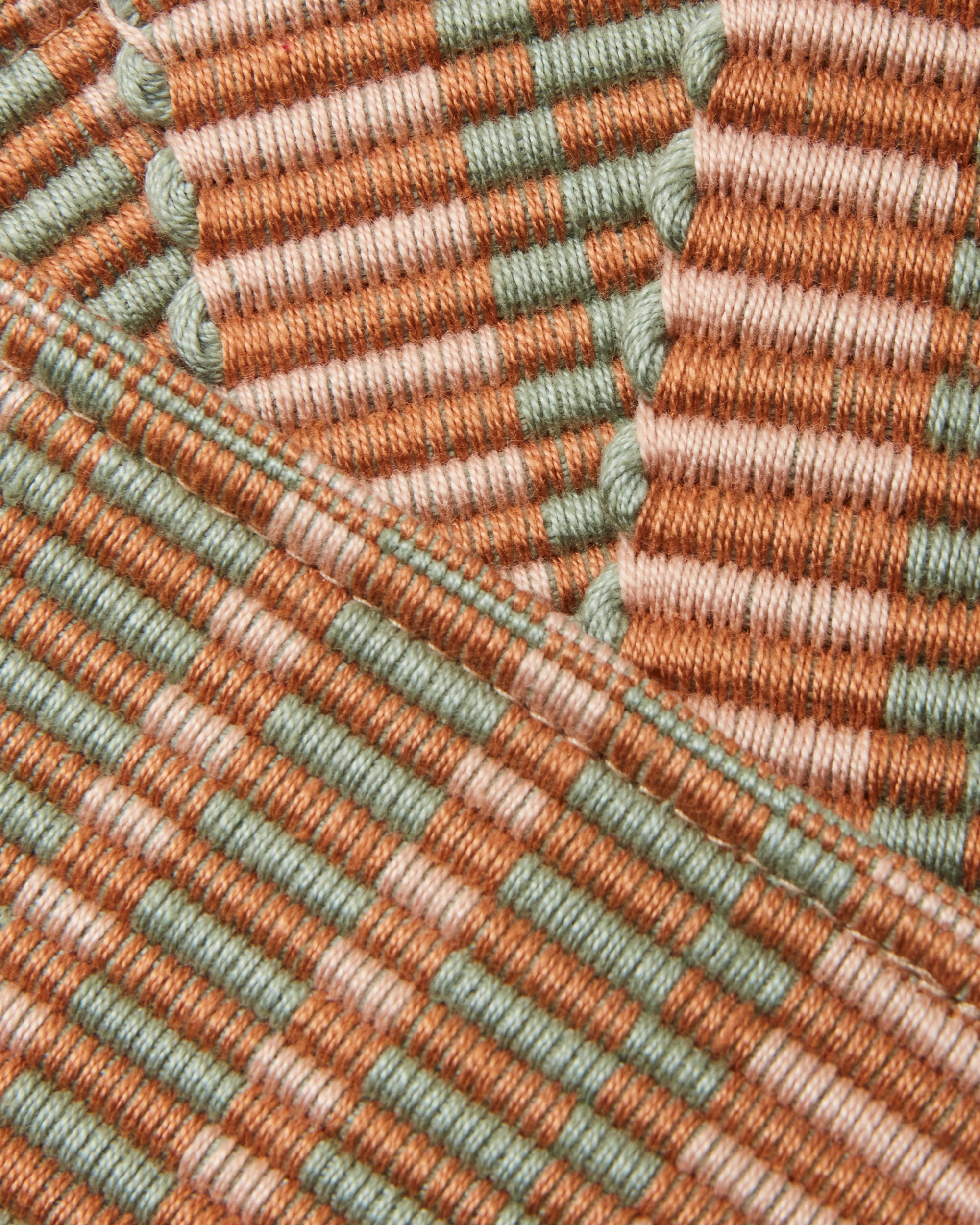 close-up detail of ethically handwoven cotton MINNA coaster terracotta, light pink, sage