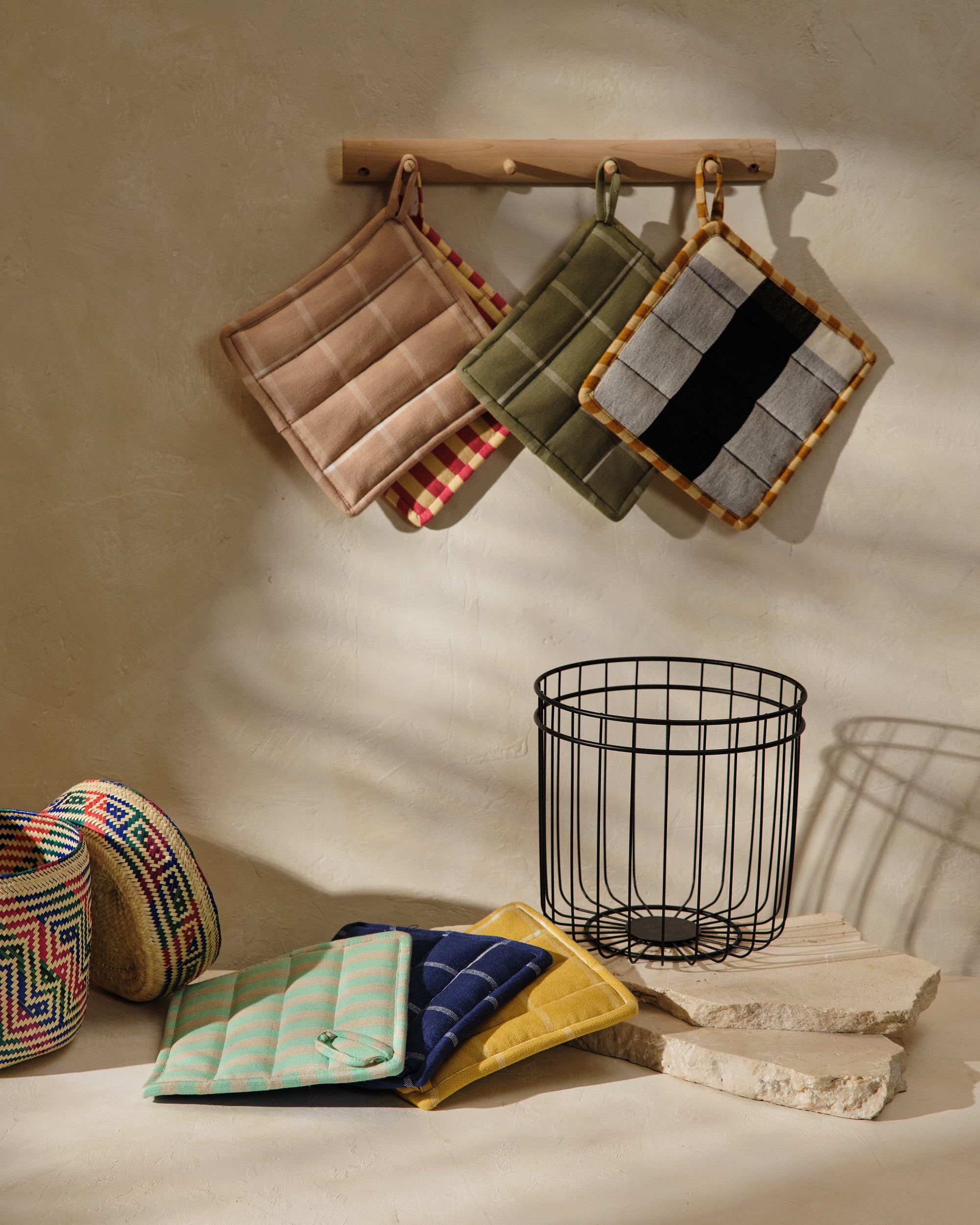 Ethically handwoven and handmade MINNA pot holders in grid and stripe colorways. Ethically made kitchen decor.