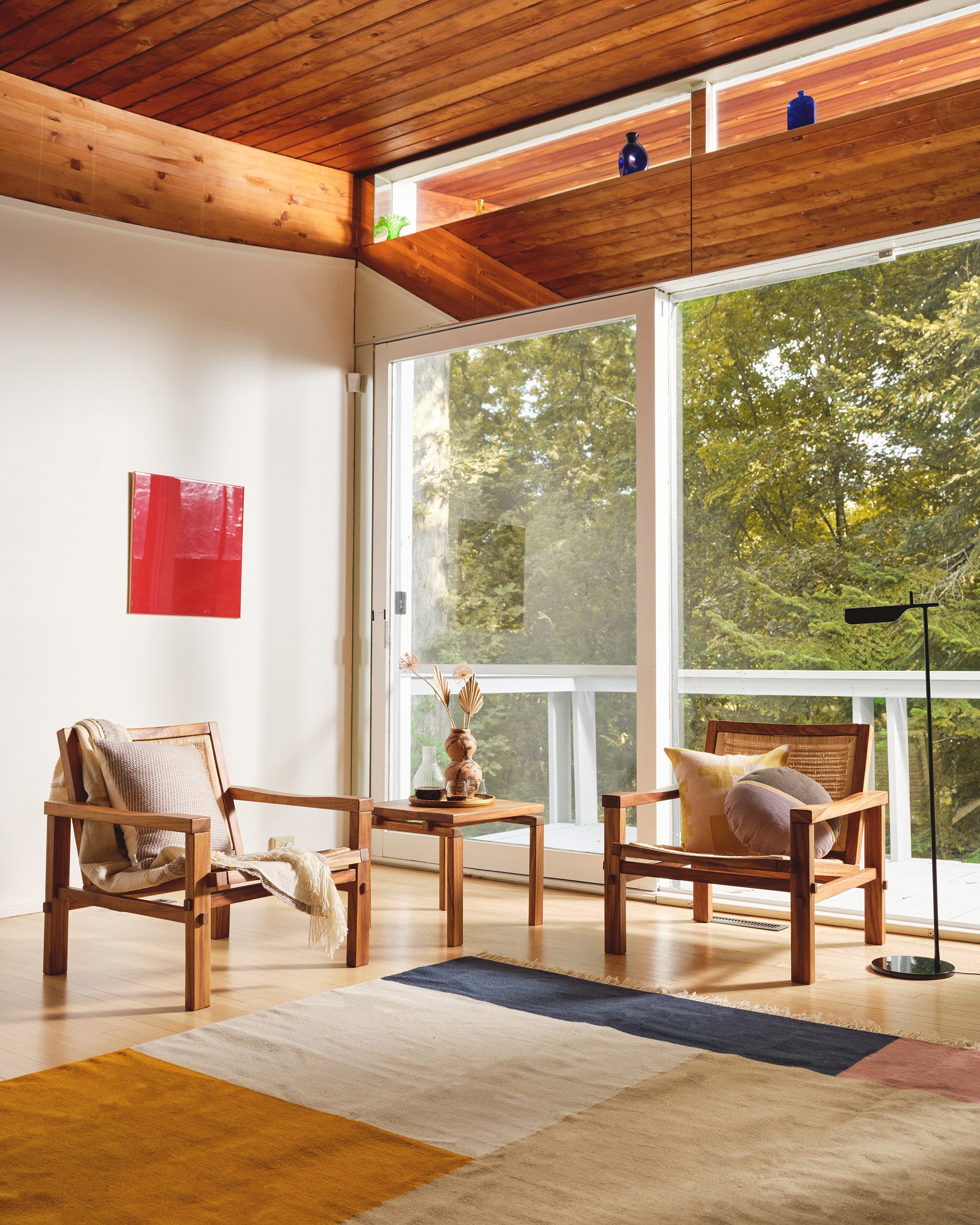 a grand mid-century modern living room with large flat weave naturally dyed rug by MINNA. 