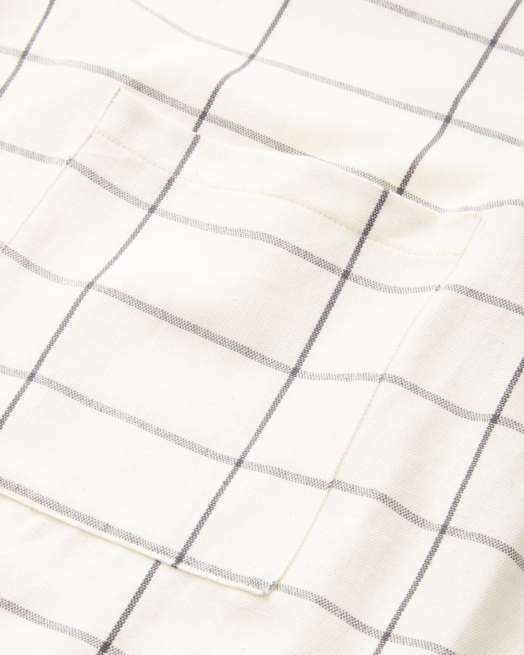 MINNA ethically handwoven 100% cotton apron with cream grid pattern