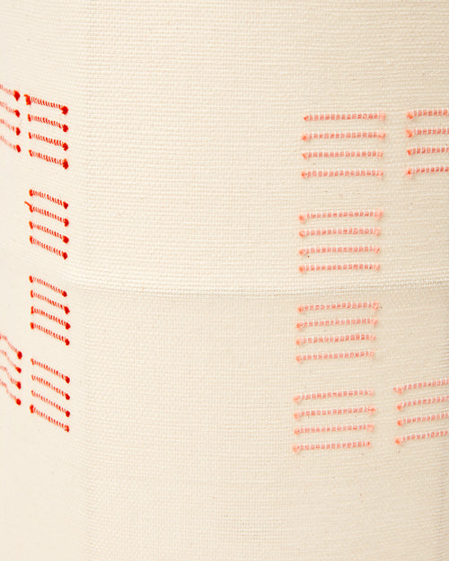 Close-up detail of ethically handwoven cotton MINNA blocks rust fabric used as a lampshade.
