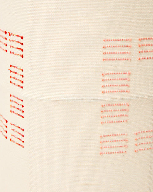 Close-up detail of ethically handwoven cotton MINNA blocks rust fabric used as a lampshade.
