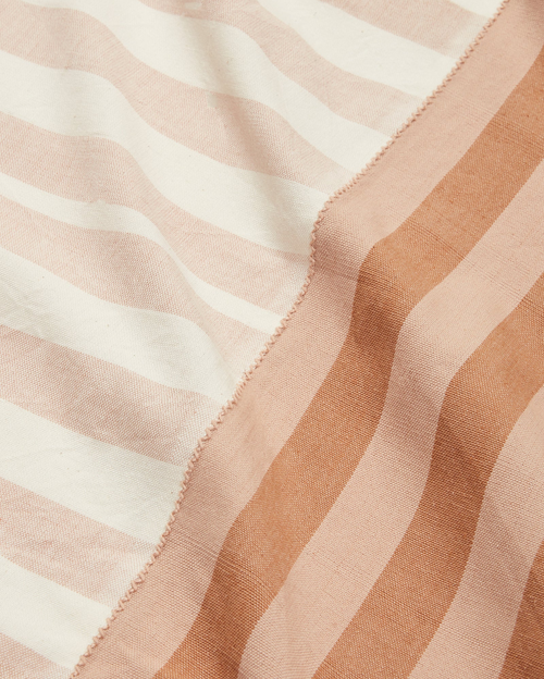 close-up of striped cotton tablecloth ethically handwoven by MINNA in neutral beige and light brown.