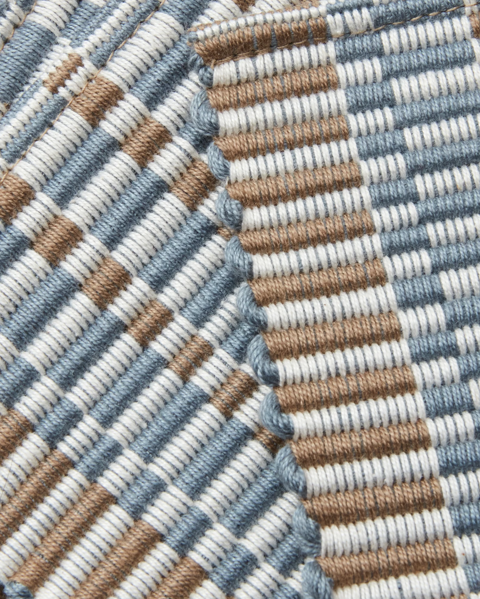 close-up detail of ethically handwoven cotton coaster, texture, light blue, cream, taupe