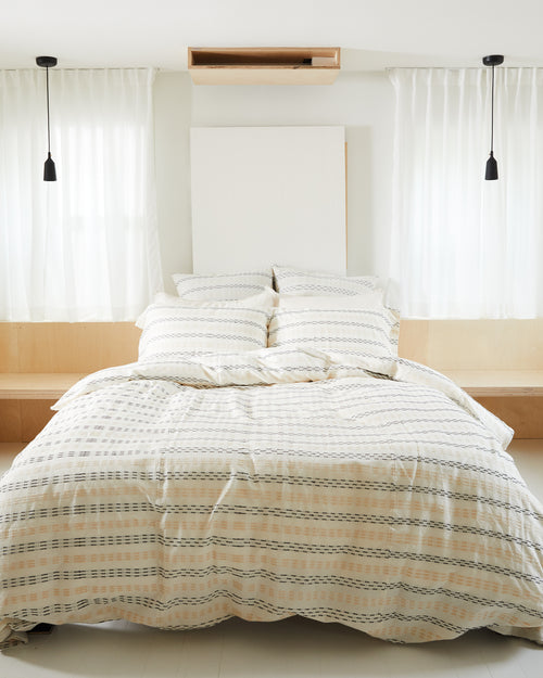 minimal bedroom with ethically handwoven oeko-tex certified cotton textural bedding designed by MINNA in neutral colors
