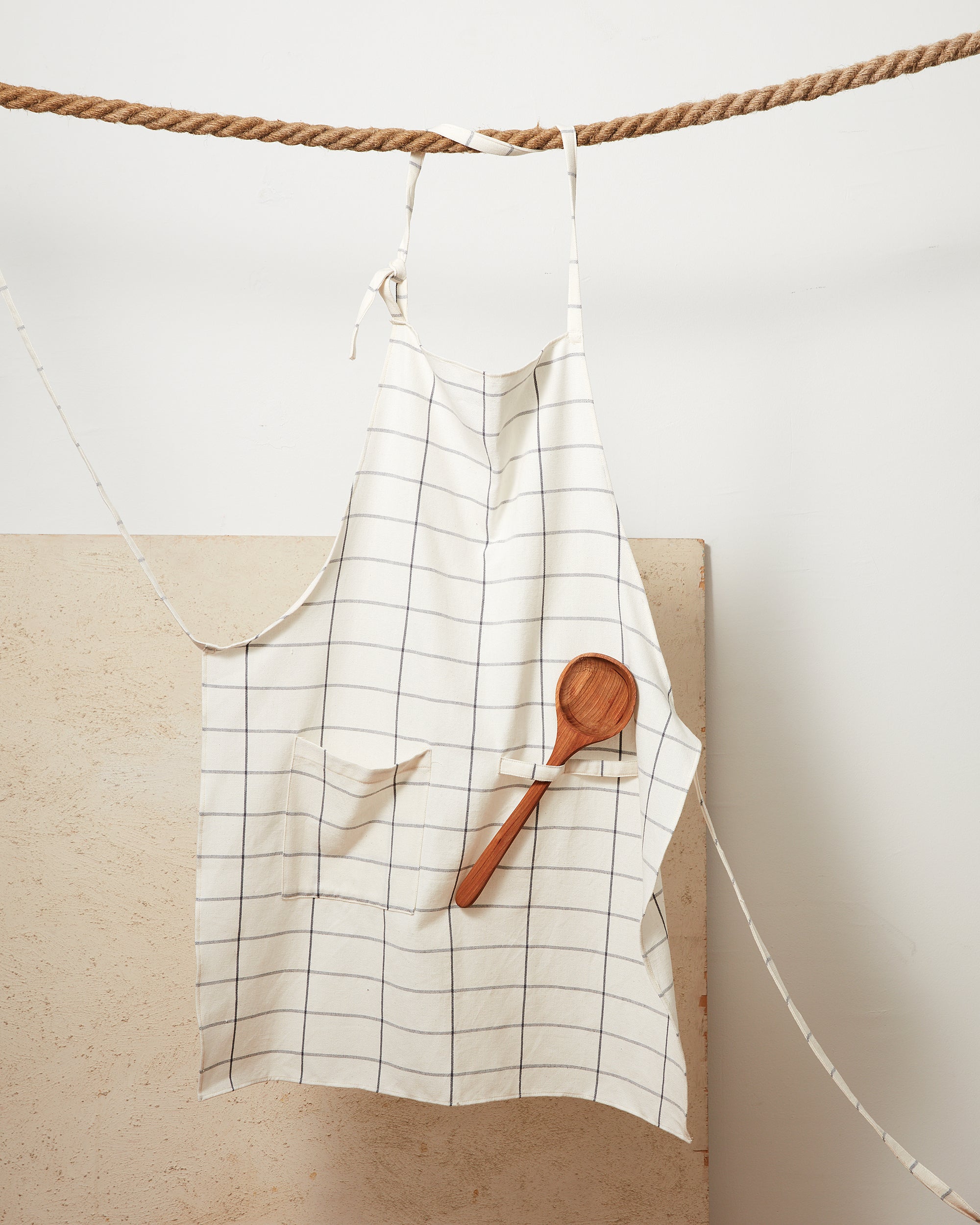 MINNA ethically handwoven 100% cotton apron with cream grid pattern