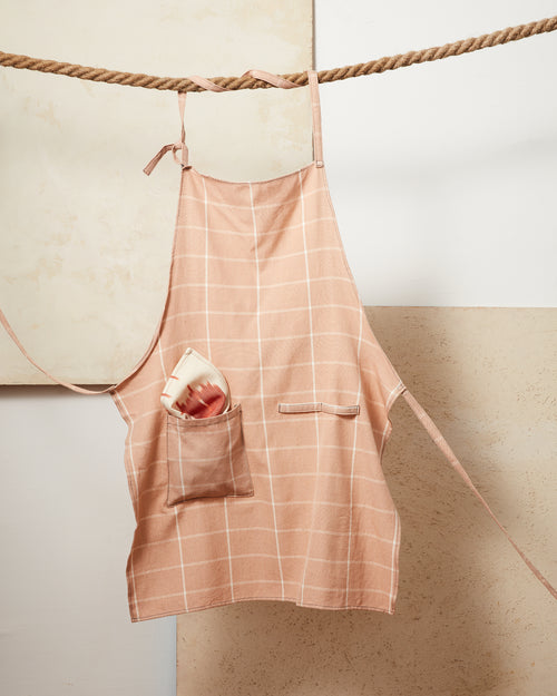 MINNA ethically handwoven 100% cotton apron with peach, pink grid pattern