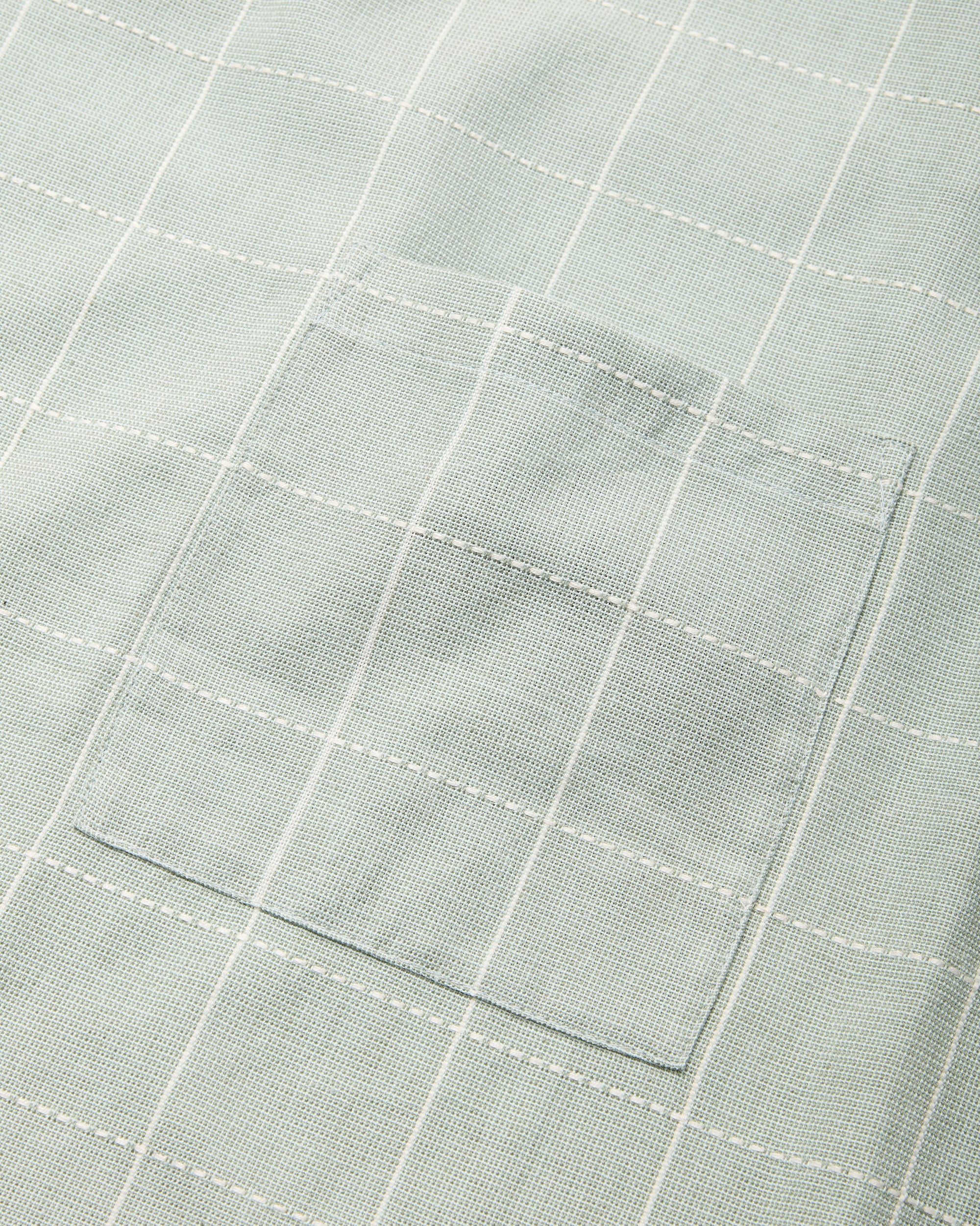 Close-up detail of handwoven ethically made Meridian Kitchen Apron by MINNA in Jay, light blue color.