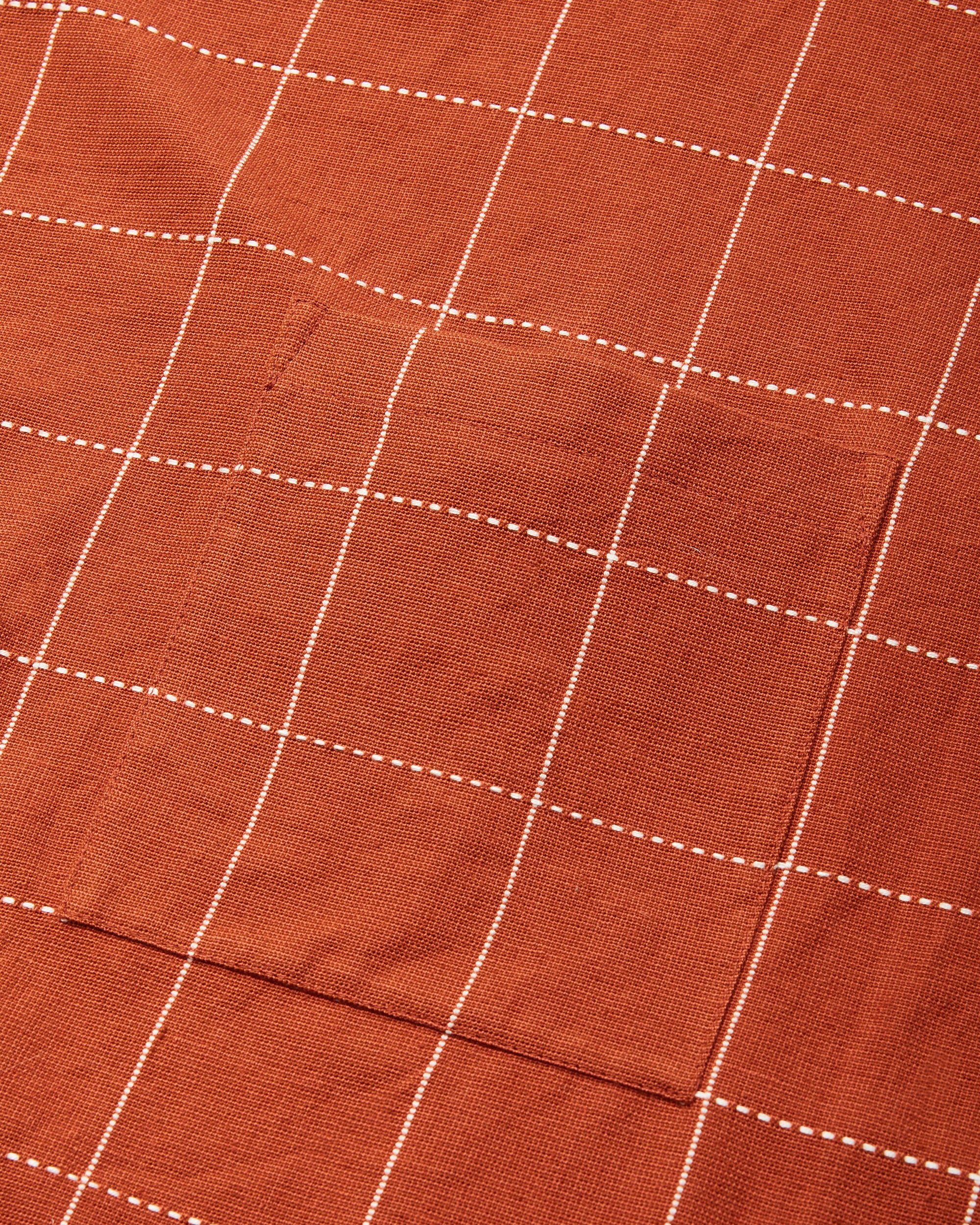 Close-up detail of handwoven ethically made Meridian Kitchen Apron by MINNA in Robin, Rust color.