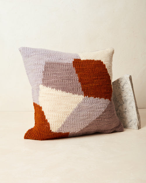 Ethically made knit graphic pillow in cream, lavender,  mauve, rust.