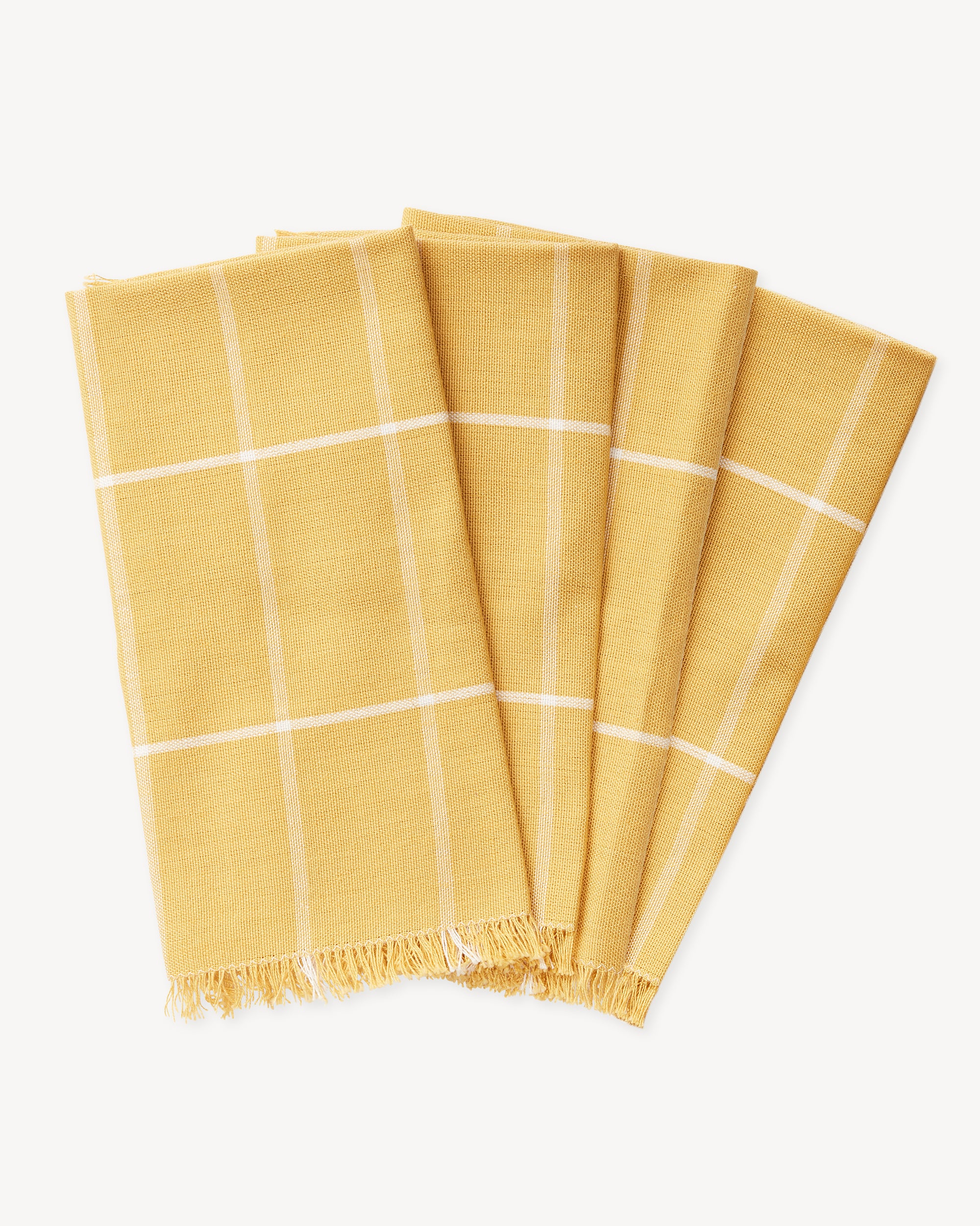 Ethically handwoven MINNA napkins with gold grid pattern, yellow