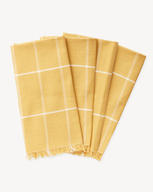Ethically handwoven MINNA napkins with gold grid pattern, yellow