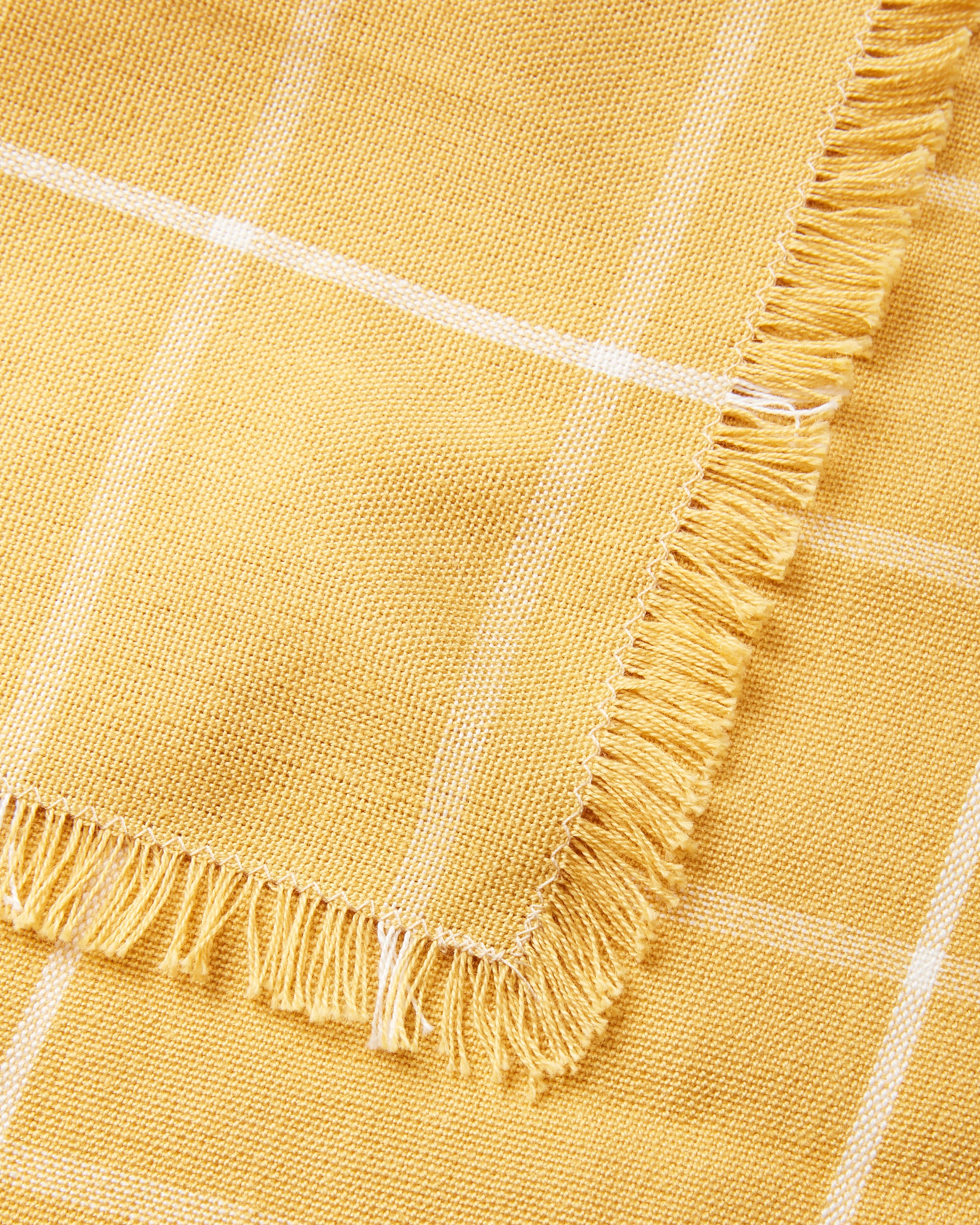 Detail, ethically handwoven MINNA napkins with gold grid pattern, yellow