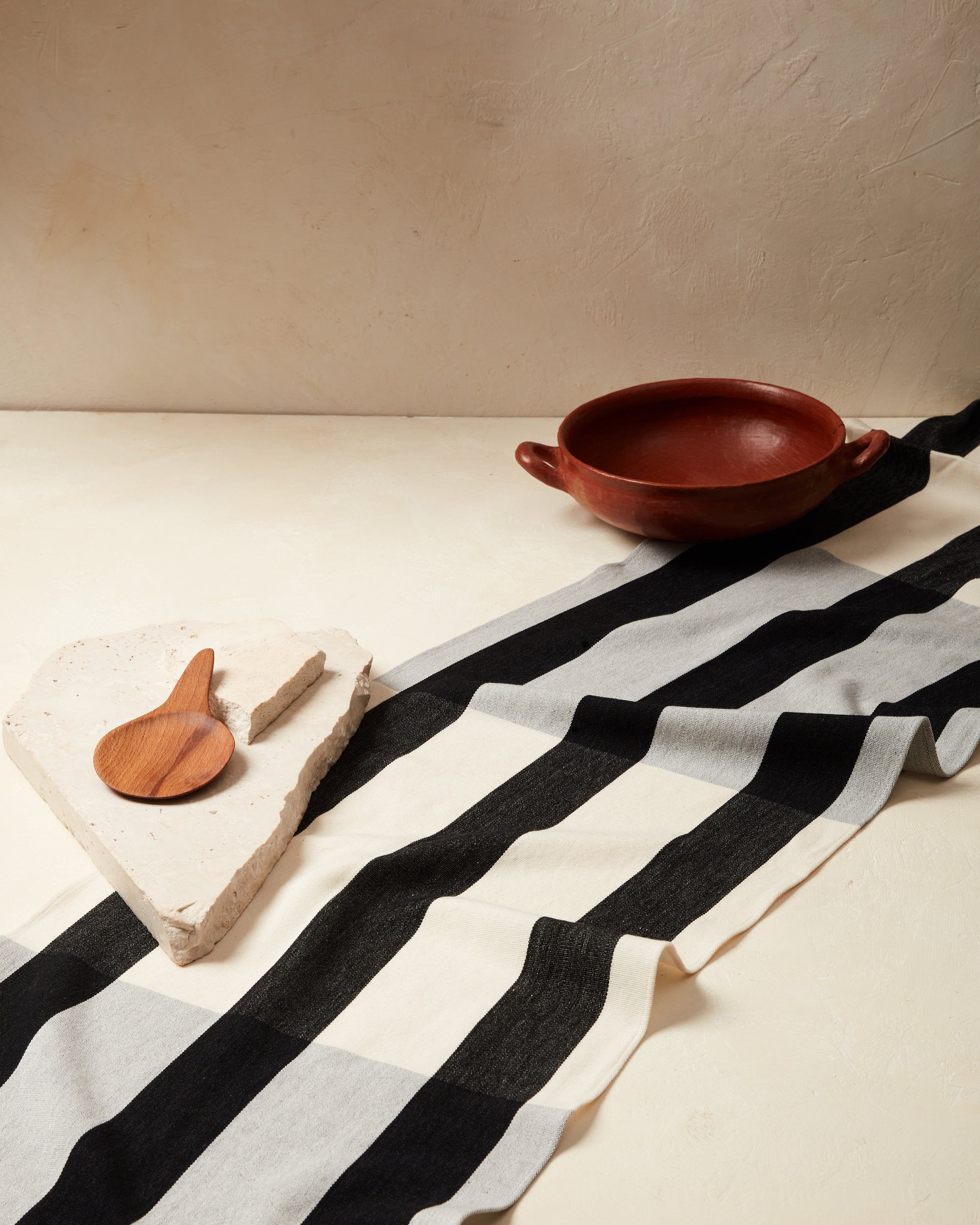 Ethically handwoven cotton Sol Runner Black, with black and white stripes. Ethically made table decor.