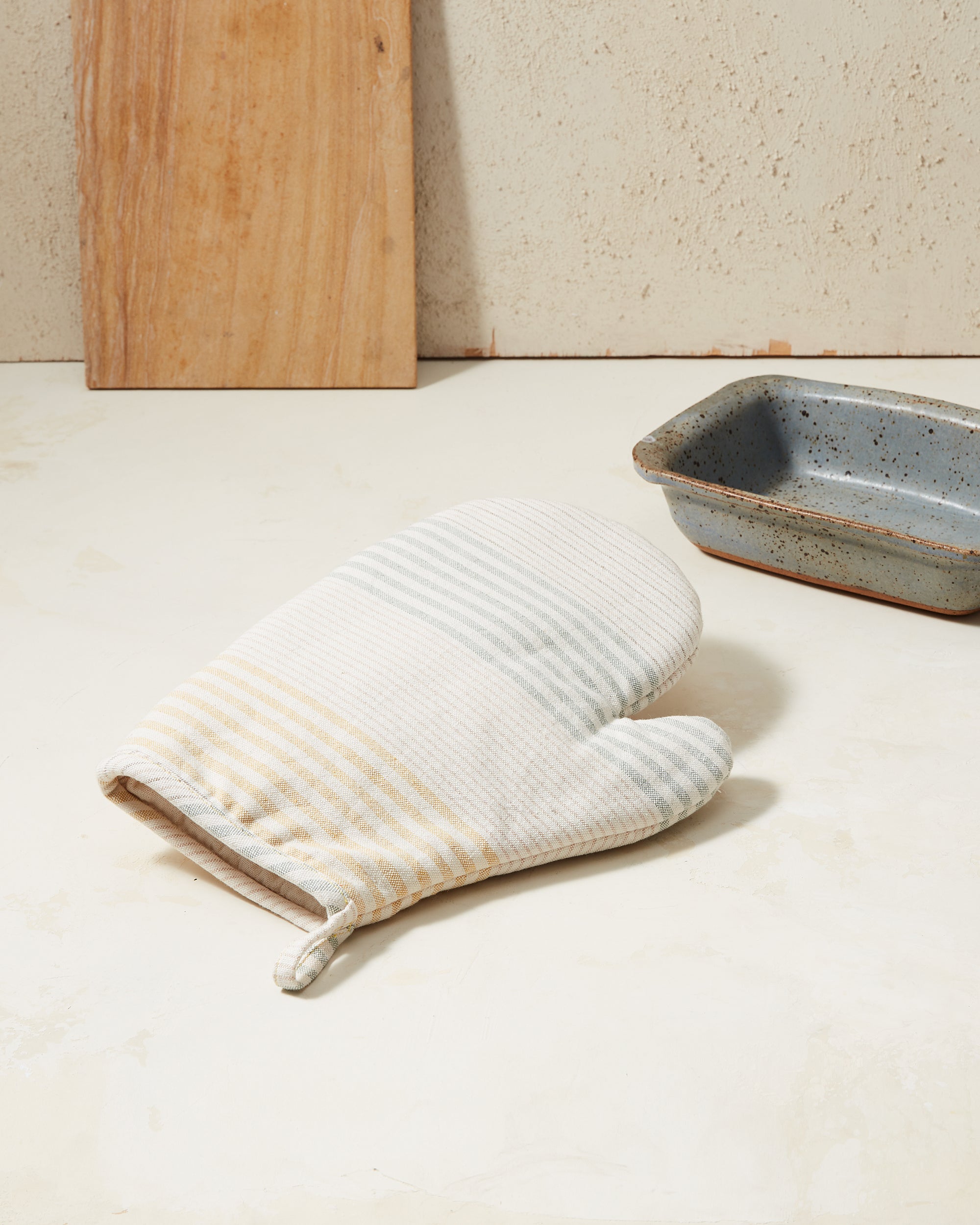 Ethically handwoven oven mitt with light yellow and sage green stripes MINNA