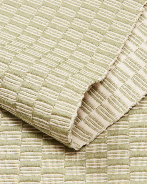 close-up detail ethically handwoven cotton table runner sage green