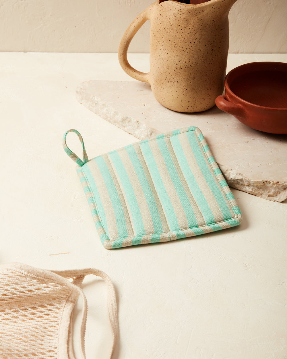 https://www.minna-goods.com/cdn/shop/products/Reversible-Potholder-Green-styled_1000x.jpg?v=1625680608