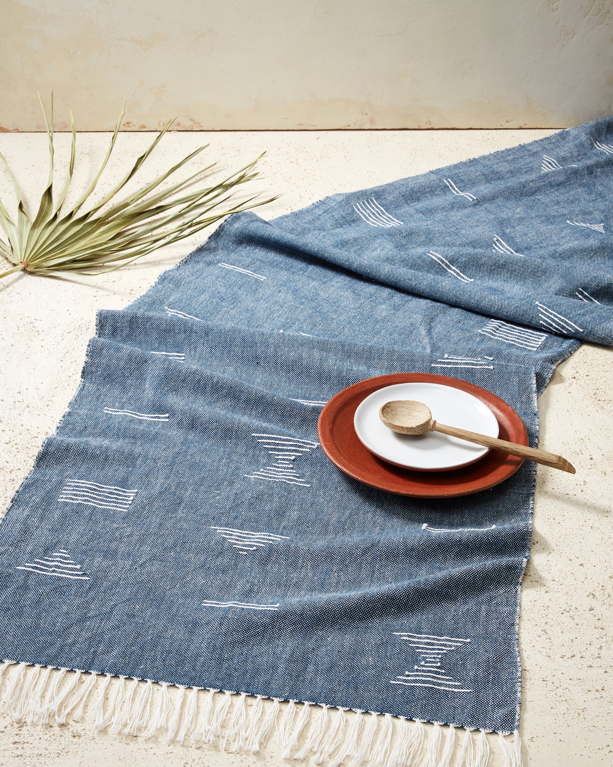 Ethically handwoven table runner in blue with white geometric shapes