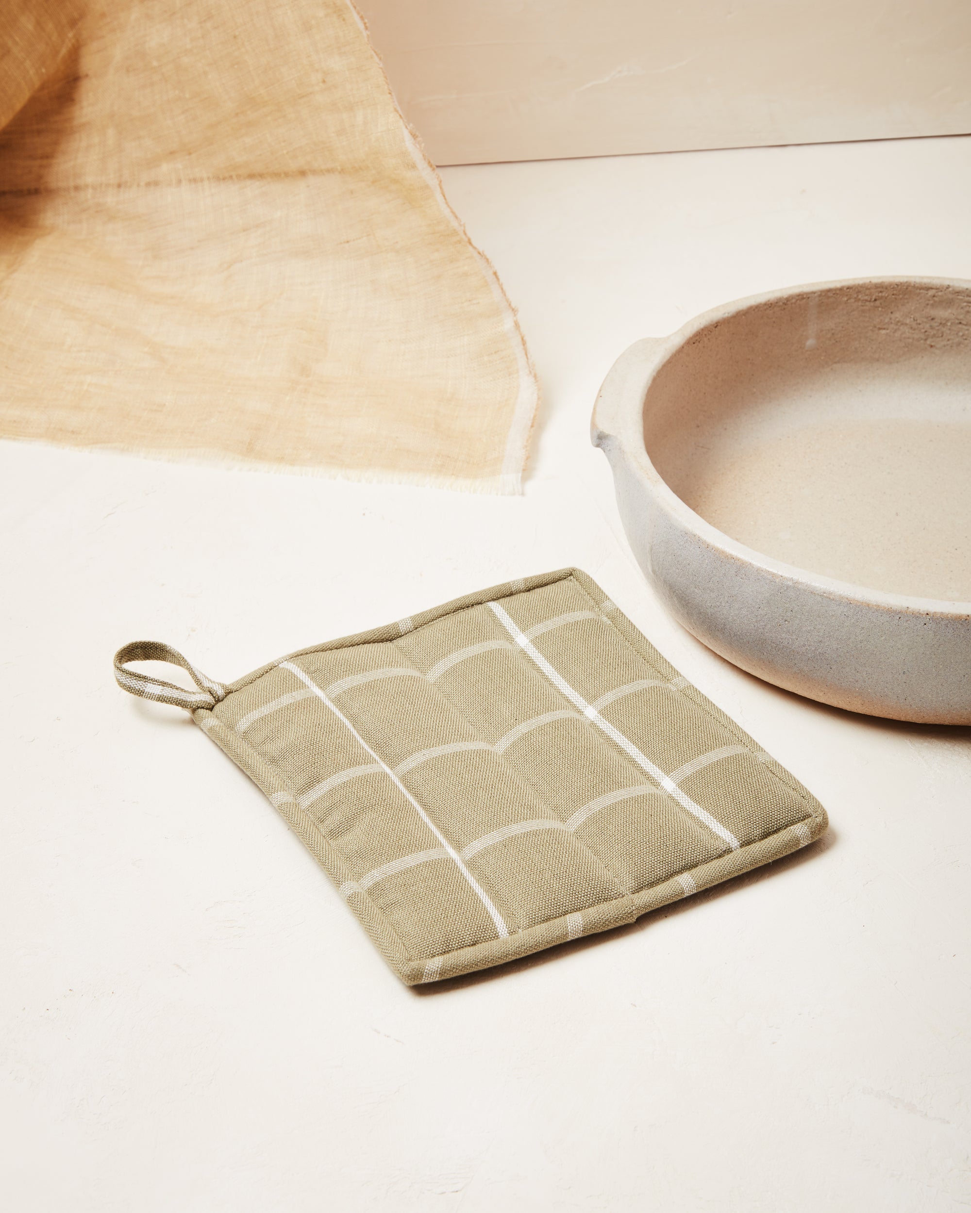 Ethically handwoven cotton potholder designed by MINNA in sage grid.