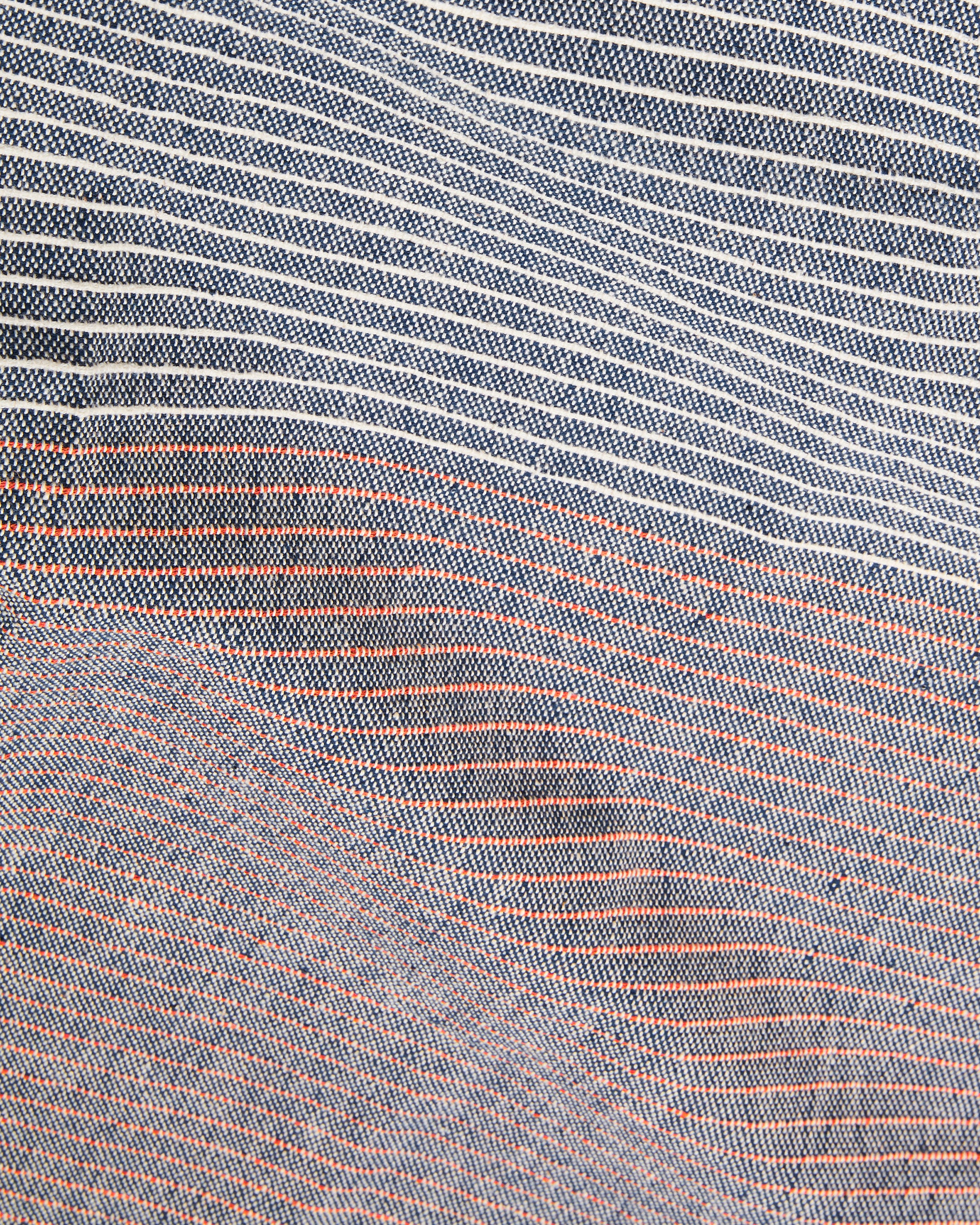 close-up detail of handwoven MINNA tablecloth with textural stripes in dark blue with rust and cream stripes