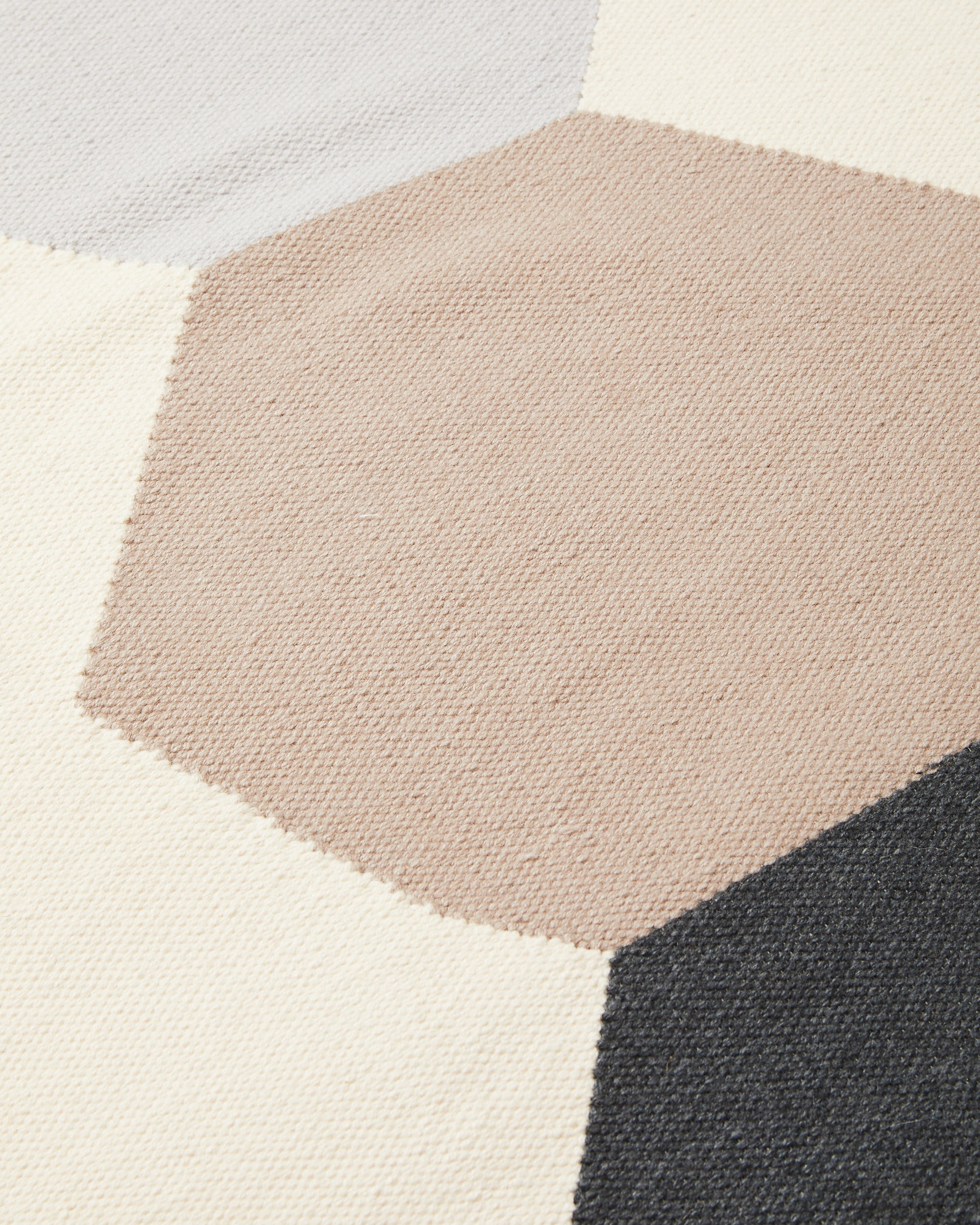 close-up detail of ethically handwoven wool flatweave MINNA rug in graphic shapes