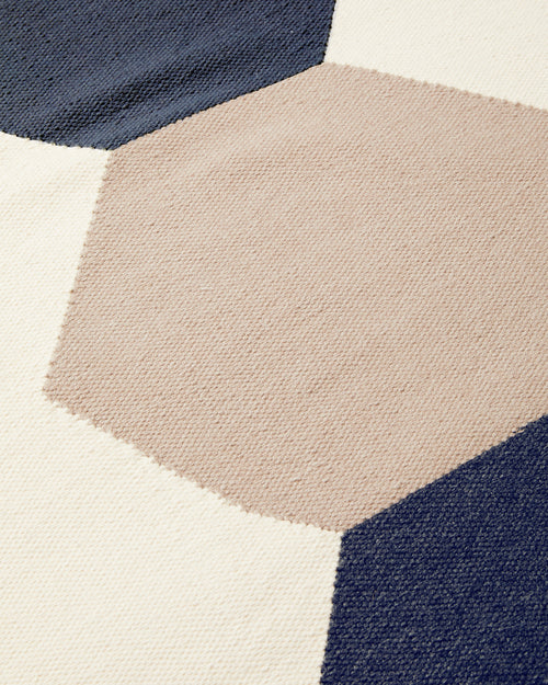 close-up detail of ethically handwoven wool flatweave MINNA rug in graphic shapes