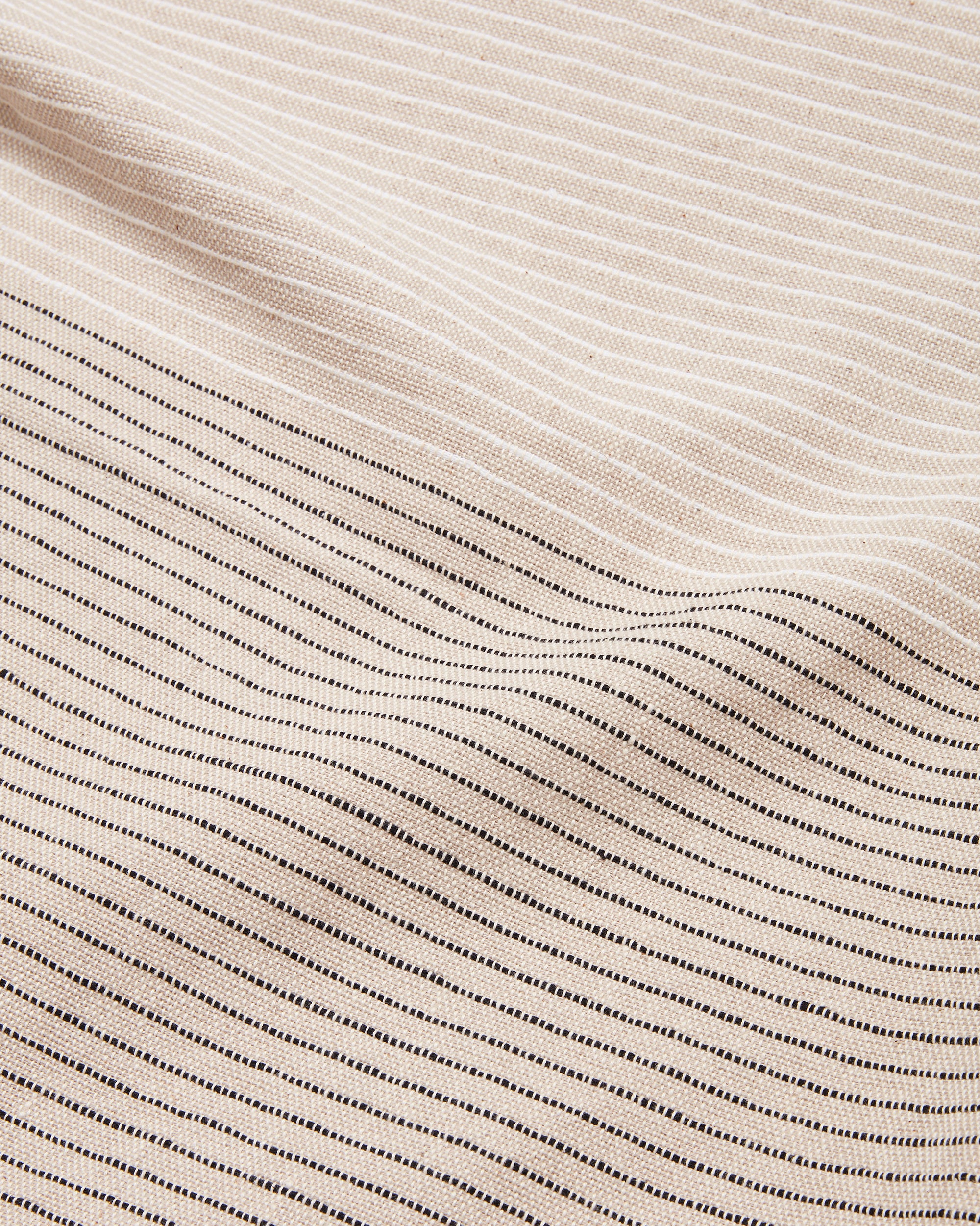 close-up detail of handwoven MINNA tablecloth with textural stripes in neutral color